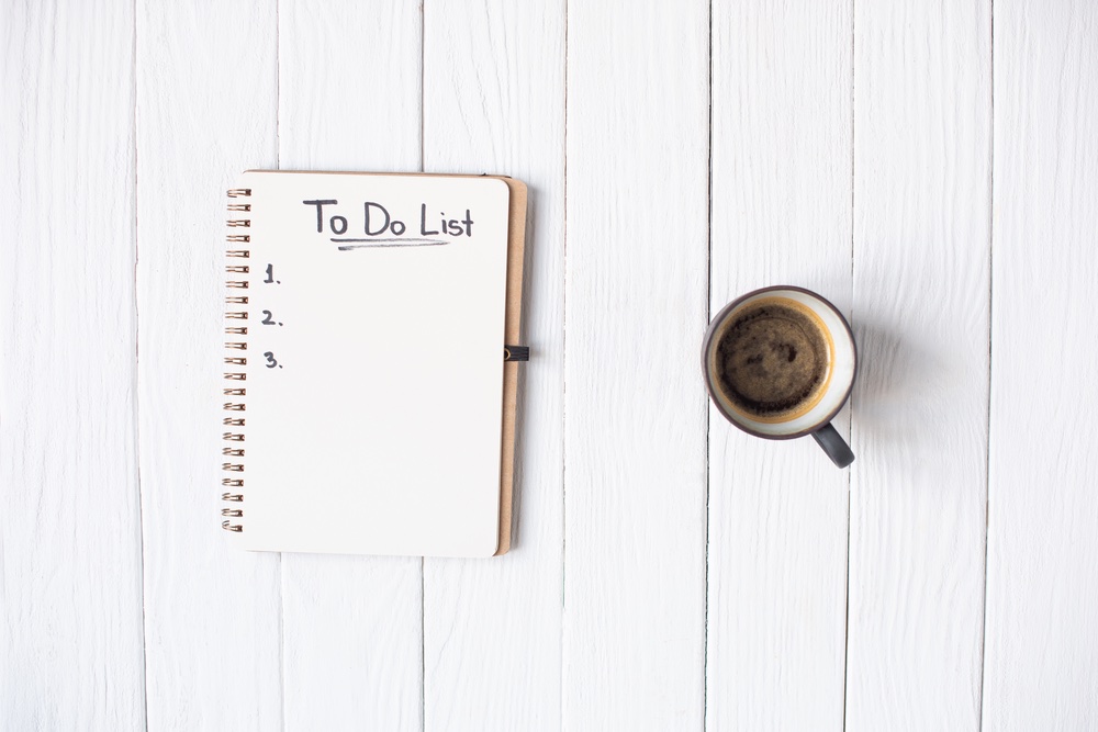 a to do list for home maintenance and a cup of coffee